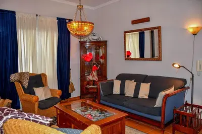 a living room with a couch and a coffee table at Bluehouse Paraiso á beira Mar in São Vicente