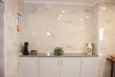 a kitchen with white cabinets and a counter top at Luxury Villa with ocean view in Luz