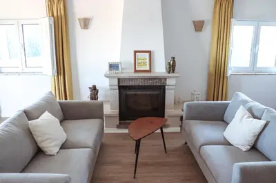 a living room with two couches and a fireplace at Luxury Villa with ocean view in Luz