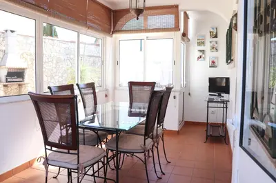 a dining room with a glass table and chairs at Luxury Villa with ocean view in Luz