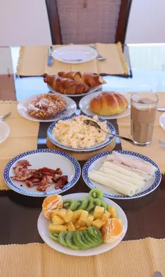 a table with plates of food on top at Luxury Villa with ocean view in Luz