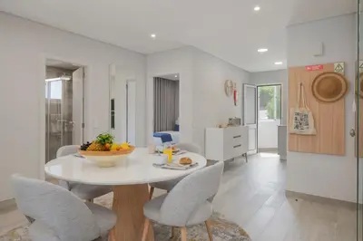 a kitchen and dining room with a table and chairs at Barreiros III by An Island Apart in Funchal