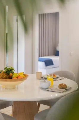 a white table with a plate of fruit on it at Barreiros III by An Island Apart in Funchal