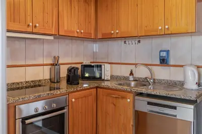 a kitchen with a sink and a microwave at OurMadeira - Casa Florenças in Calheta
