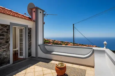 a balcony with a bathtub on the side of a house at OurMadeira - Casa Florenças in Calheta