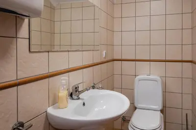 a bathroom with a sink and a toilet and a mirror at OurMadeira - Casa Florenças in Calheta