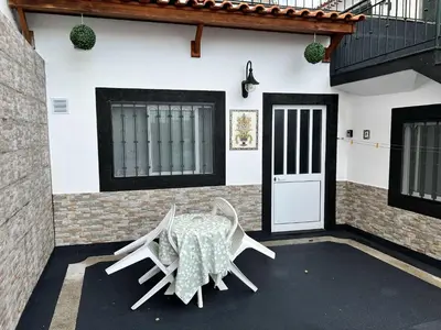 a table and chairs in front of a house at Funchal-Studio-Sleeps4-FreeParking in Funchal