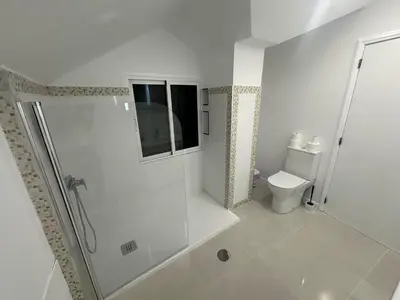 a white bathroom with a shower and a toilet at Funchal-Studio-Sleeps4-FreeParking in Funchal