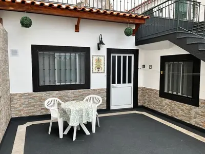 a table and chairs in front of a house at Funchal-Studio-Sleeps4-FreeParking in Funchal