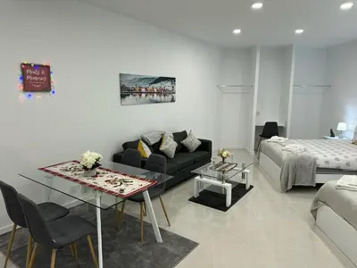 a living room with a couch and a table at Funchal-Studio-Sleeps4-FreeParking in Funchal