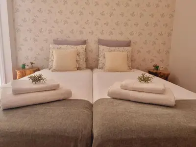 a bedroom with two beds with towels on them at The Beach House in Porto Santo