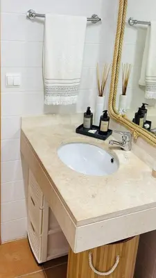 a bathroom with a sink and a mirror at The Beach House in Porto Santo