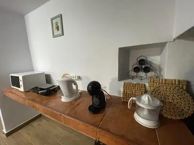 a kitchen counter with a microwave and appliances on it at Casa Rustica da Maloeira in Fajã da Ovelha