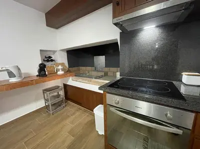 a kitchen with a stove and a counter top at Casa Rustica da Maloeira in Fajã da Ovelha