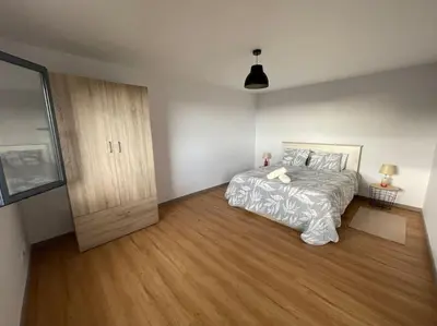a bedroom with a bed and a wooden floor at Casa Rustica da Maloeira in Fajã da Ovelha