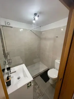 a bathroom with a shower and a toilet and a sink at Casa Rustica da Maloeira in Fajã da Ovelha