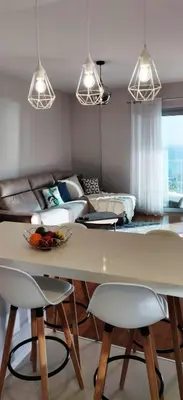 a living room with a table and chairs and a couch at Formosa Ocean View - 142109/AL in Funchal