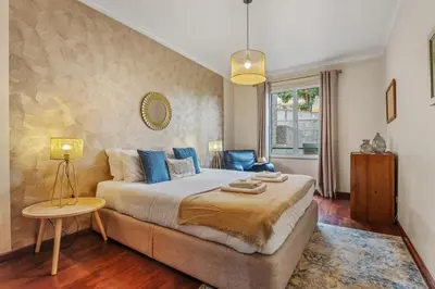 a bedroom with a large bed with blue pillows at Catybel by Homie in Funchal