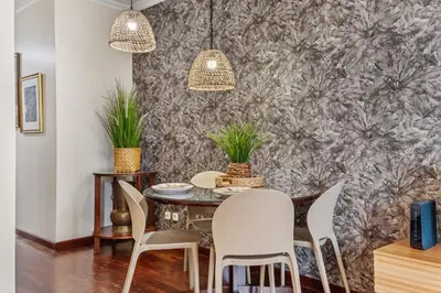 a dining room with a table and chairs at Catybel by Homie in Funchal
