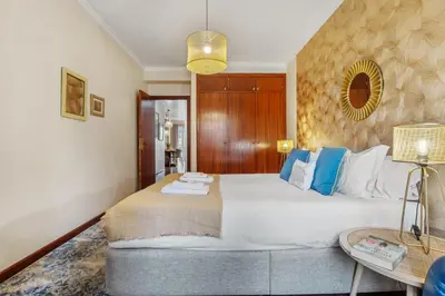 a bedroom with a large bed and a table at Catybel by Homie in Funchal