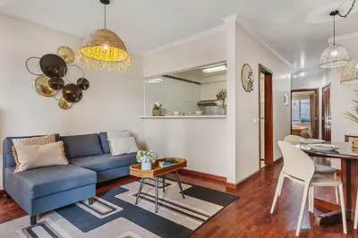 a living room with a blue couch and a table at Catybel by Homie in Funchal