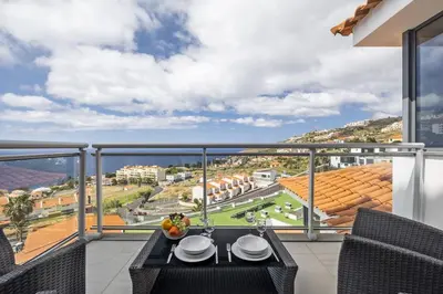 a balcony with a table and chairs and a view at Cote D Atlantique by Homie in Caniço
