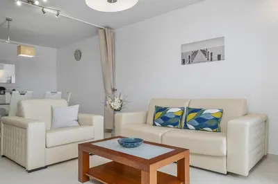 a living room with two chairs and a coffee table at Cote D Atlantique by Homie in Caniço