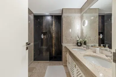 a bathroom with two sinks and a shower at The Suite QM in Funchal