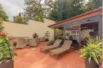 a patio with a bunch of chairs and a table at The Suite QM in Funchal