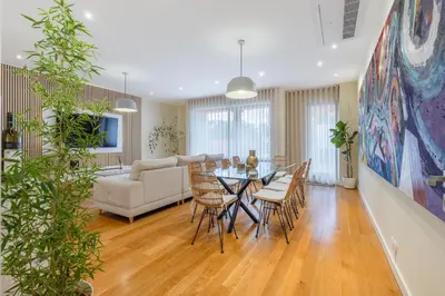 a dining room and living room with a table and chairs at The Suite QM in Funchal