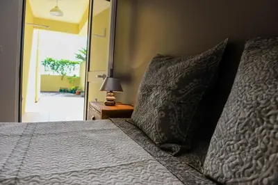 a bedroom with a bed with pillows and a mirror at Bela Vista Capazi in Porto Santo