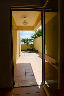 an open door to a hallway with a tile floor at Bela Vista Capazi in Porto Santo