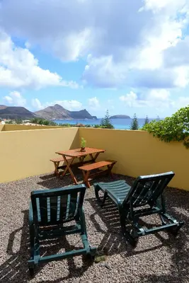 two chairs and a picnic table and a table and chairs at Bela Vista Capazi in Porto Santo