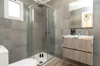 a bathroom with a shower and a toilet and a sink at Villa Liana by LovelyStay in Ponta do Sol