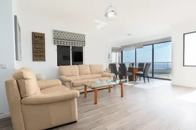 a living room with two chairs and a table at Villa Liana by LovelyStay in Ponta do Sol