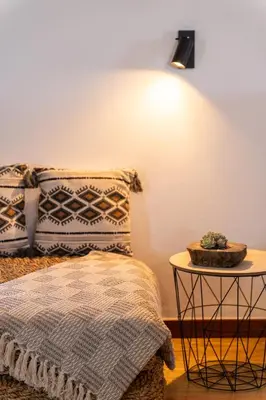 a bedroom with a large bed with a wooden headboard at Casa das Eiras, Nº48 in Santana