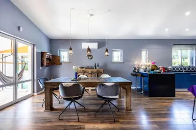 a kitchen and dining room with a wooden table and chairs at Casa Azul in Luz