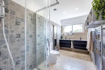 a bathroom with a toilet and a glass shower at Casa Azul in Luz