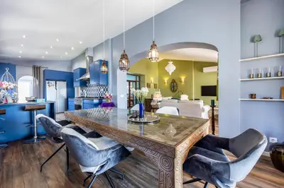 a dining room with a large wooden table and chairs at Casa Azul in Luz