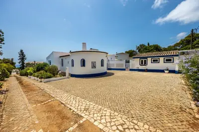 a large house with a cobblestone driveway at Casa Azul in Luz