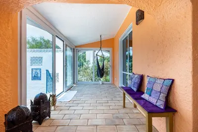 a porch with a purple bench and large windows at Casa Azul in Luz