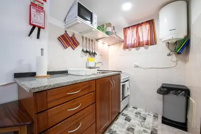 a small kitchen with a sink and a microwave at Pereira Place - Cottage in São Vicente