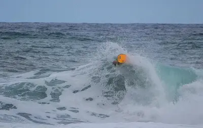 a yellow object in the middle of a wave in the ocean at Pereira Place - Cottage in São Vicente