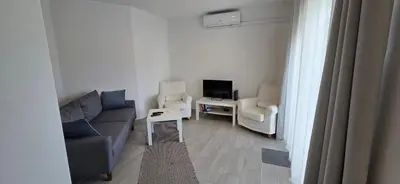 a living room with a couch and two chairs and a tv at Apartamento Cristino in Luz