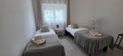 a room with two beds and a window at Apartamento Cristino in Luz