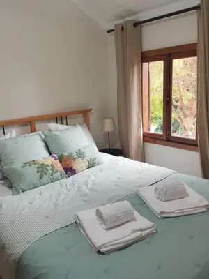 a bedroom with a large bed with blue curtains at Quinta Meneses in Santa Cruz