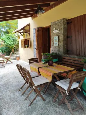 a wooden table and chairs on a patio at Quinta Meneses in Santa Cruz