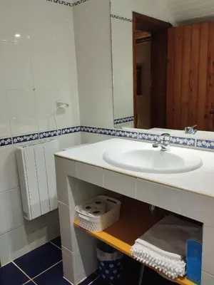 a bathroom with a sink and a mirror at Quinta Meneses in Santa Cruz
