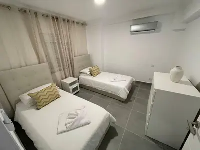 a hotel room with two beds in a room at Apartamento Don Tenório com piscina Sagres in Sagres