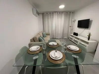 a living room with a glass table and a couch at Apartamento Don Tenório com piscina Sagres in Sagres